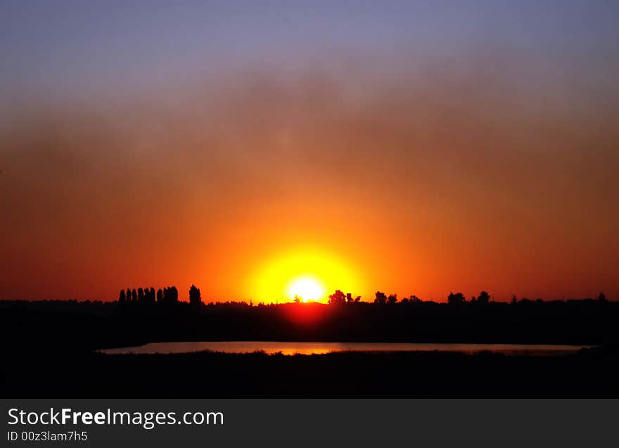 Red sunset near a lake