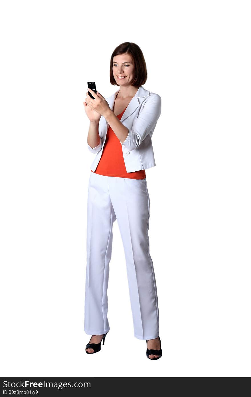 Business the woman in white clothes costing looks at a mobile phone. Business the woman in white clothes costing looks at a mobile phone