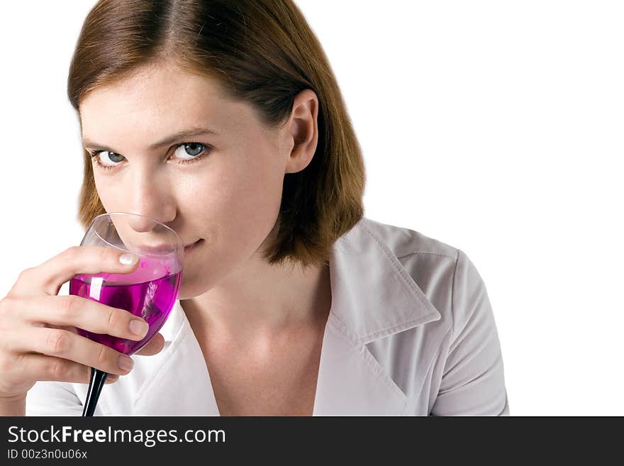 Business the woman in white clothes holds in a hand a glass with a bright drink. Business the woman in white clothes holds in a hand a glass with a bright drink