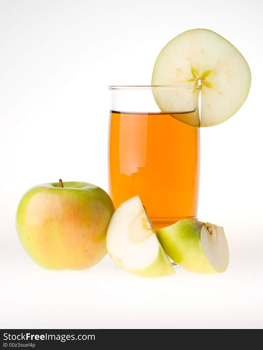 Apple and juice glass on a white background.