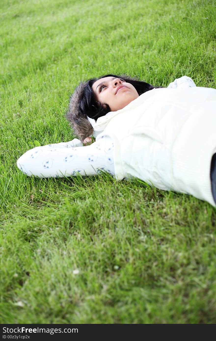 Beautiful girl lying down of grass