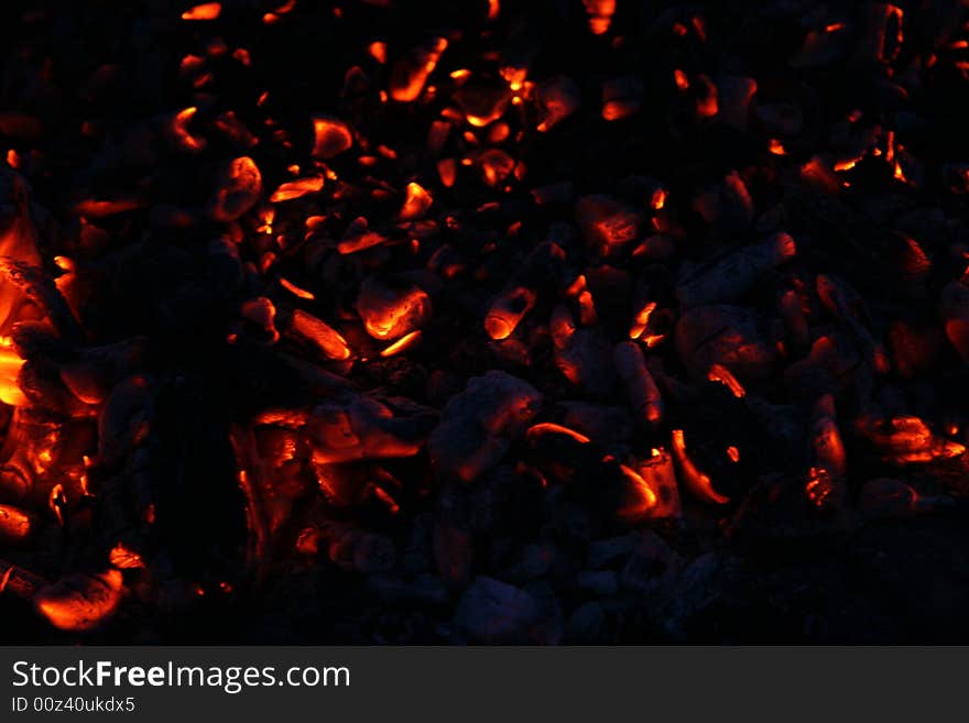 Red smolder carbons on the black background