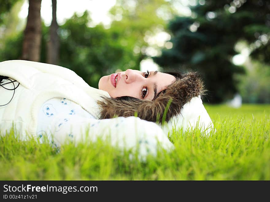 Beautiful girl lying down of grass