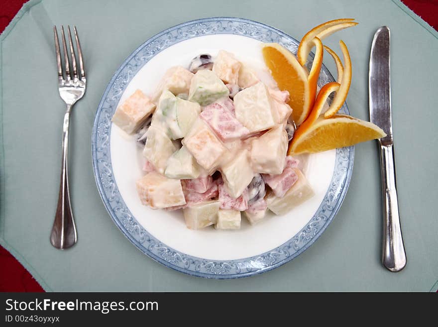 Appetizing salad on a plate with knife and fork