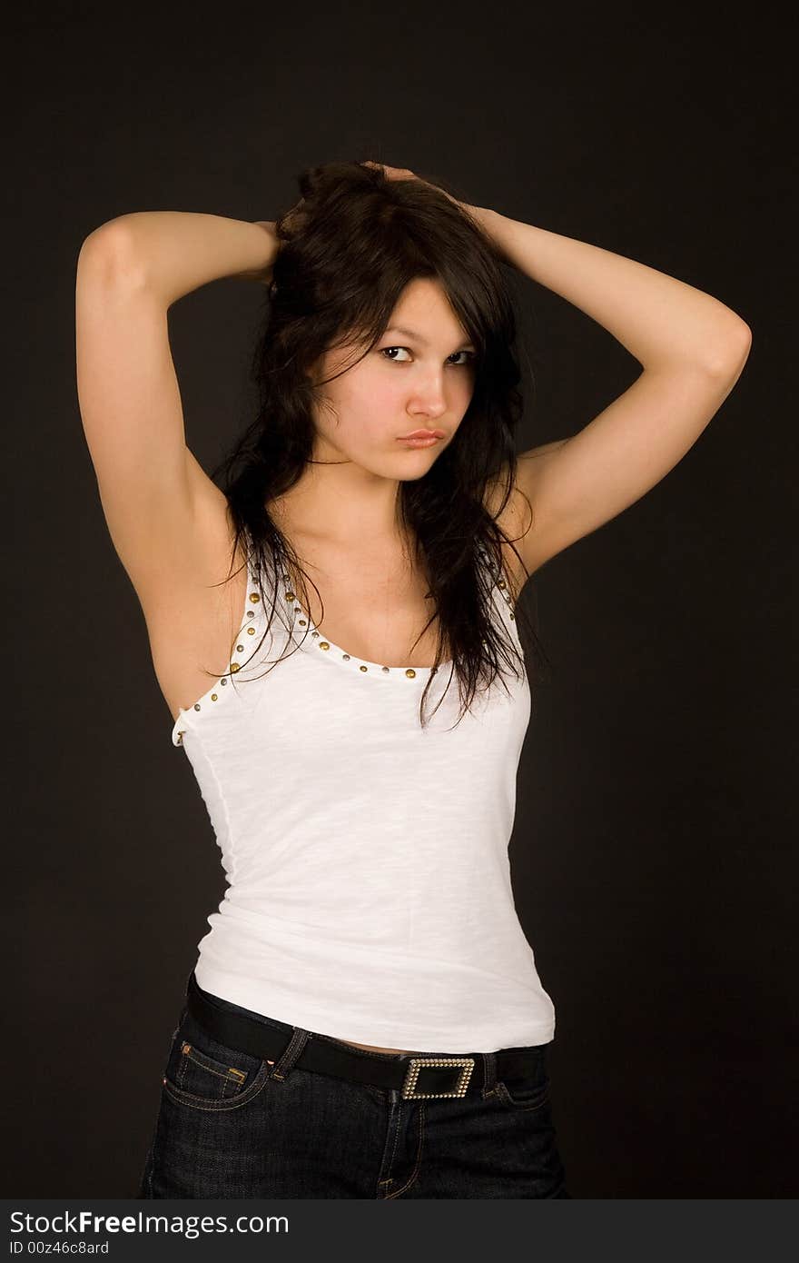 Attractive girl in white top isolated on black background