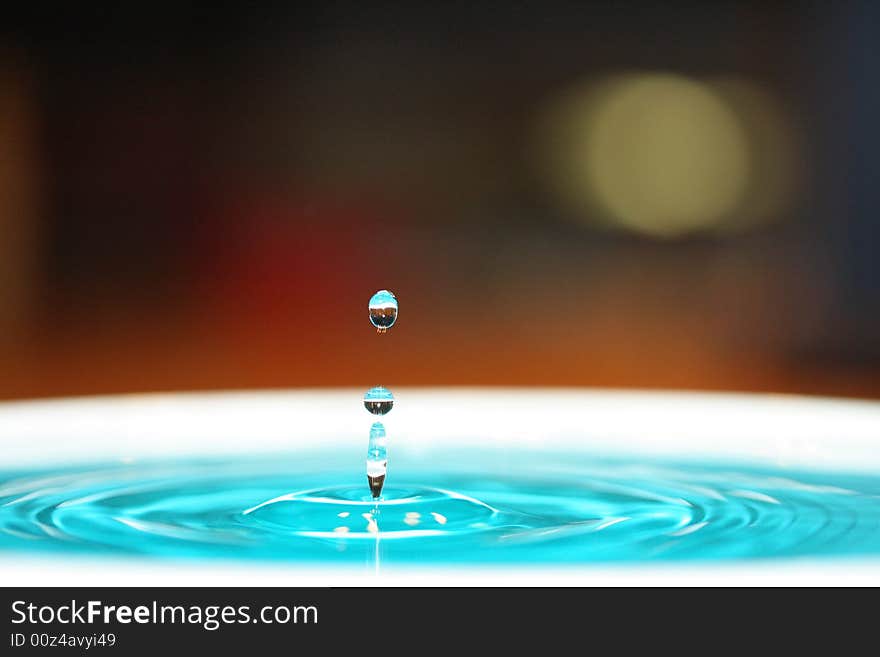 Drop of water is about to meet with the back drop. Drop of water is about to meet with the back drop