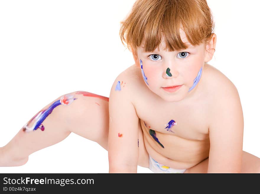 A girl with dirty face of paint seat on the floor. A girl with dirty face of paint seat on the floor