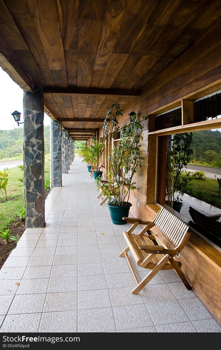 Wooden bench outside tropical hotel room