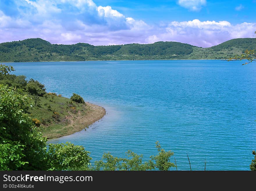 A view of mountain landscape with some water