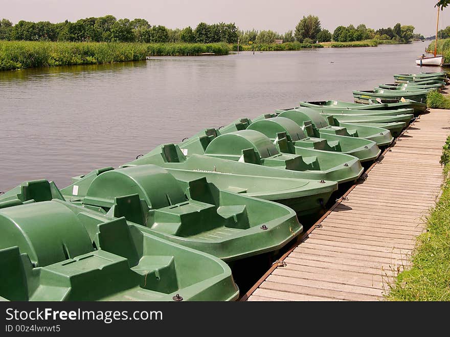 Pedal boats moored at a wooden jetty. Pedal boats moored at a wooden jetty