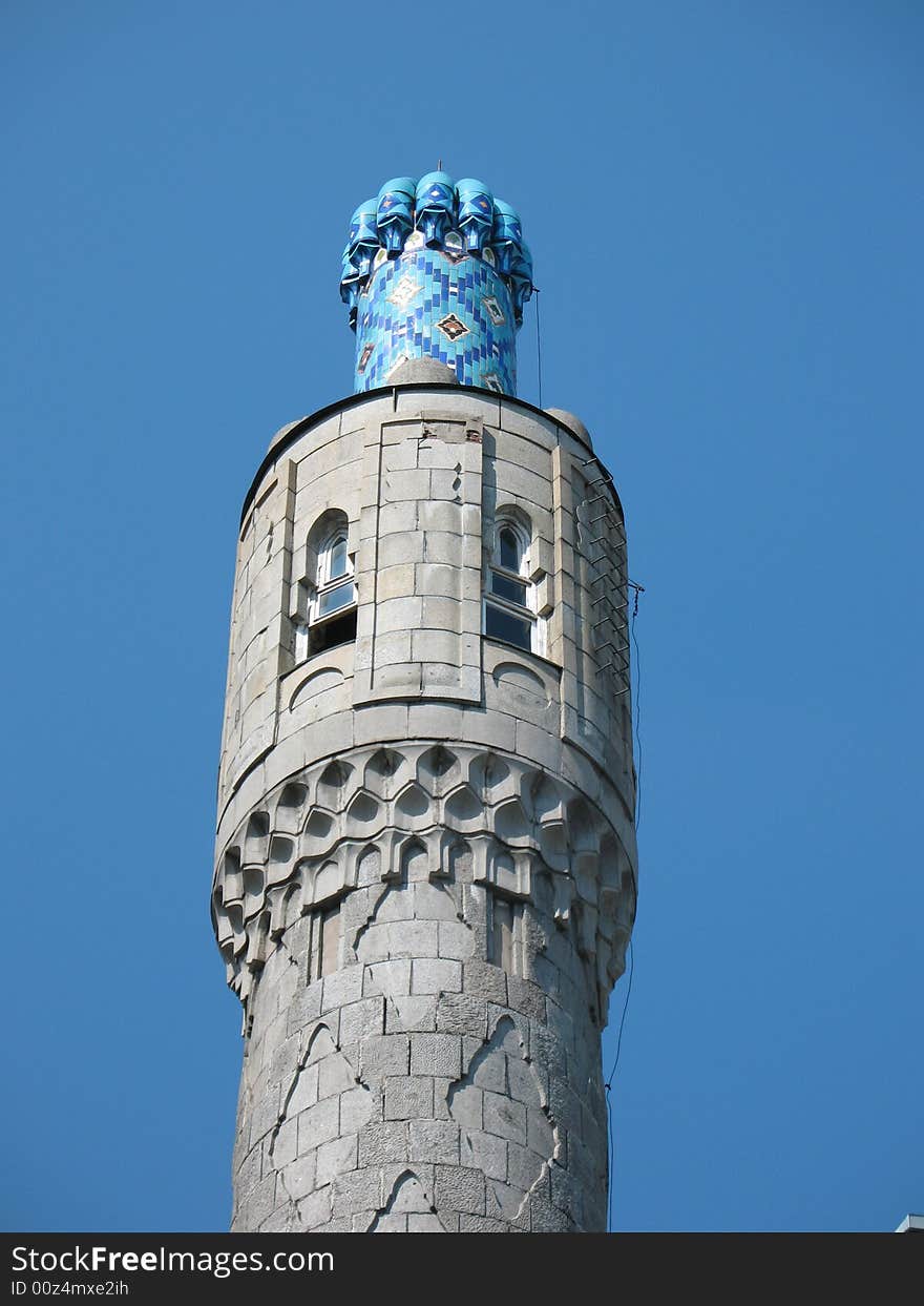 The minarets of St. Petersburg's cathedral mosque on the blue sky background. The minarets of St. Petersburg's cathedral mosque on the blue sky background