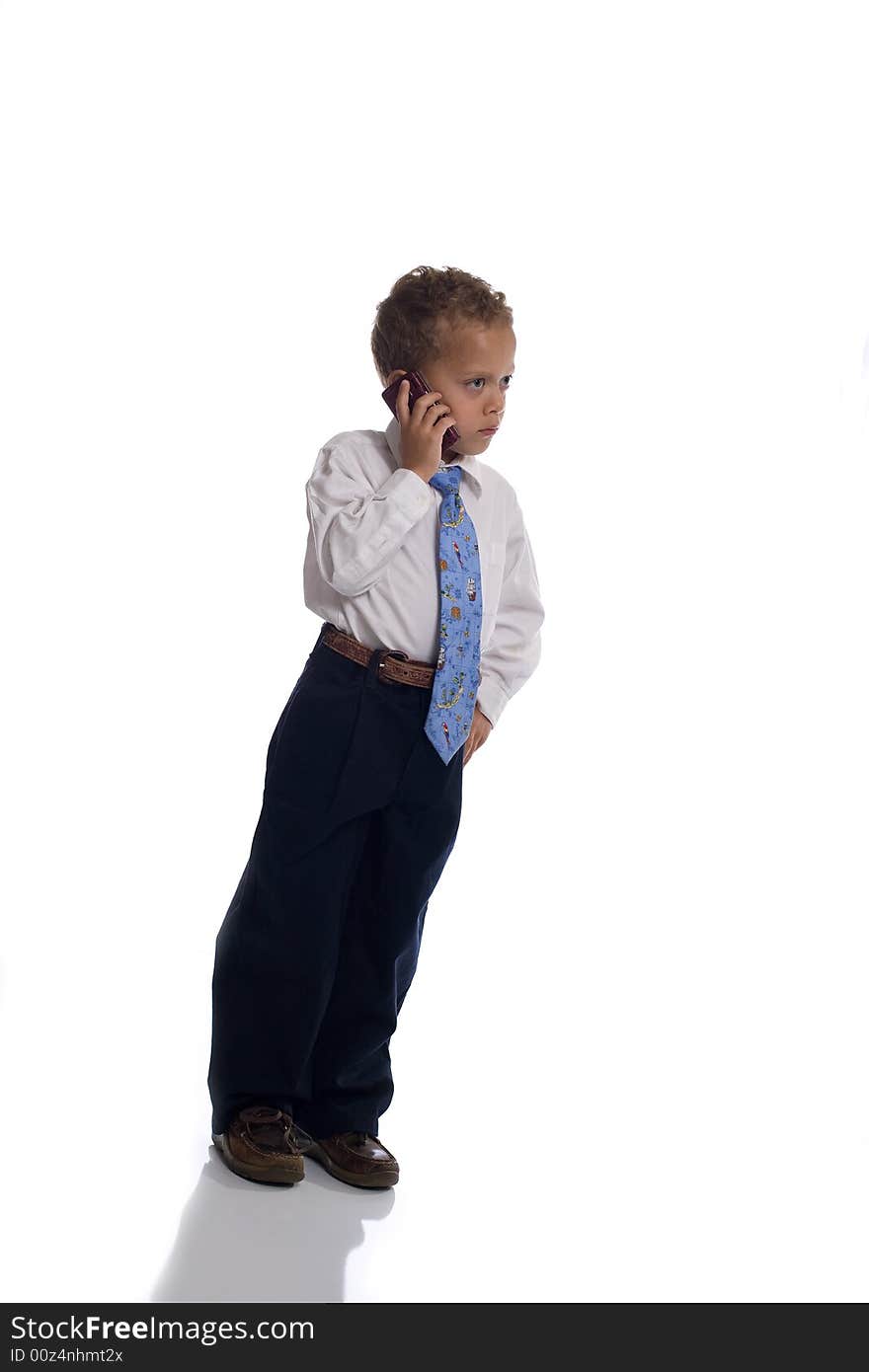 Young boy dressed as businessman uses cellphone