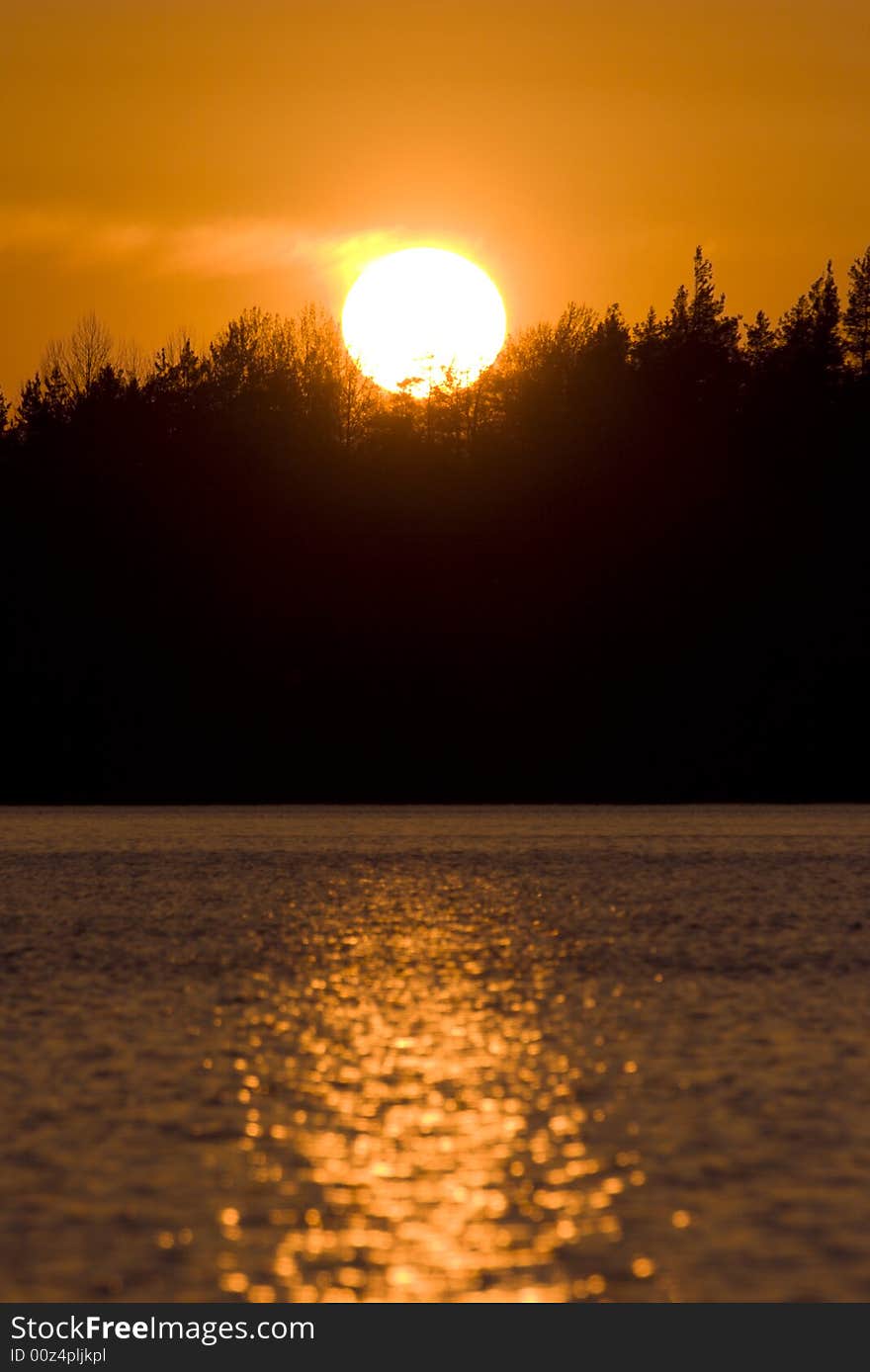 Sunset on forest lake