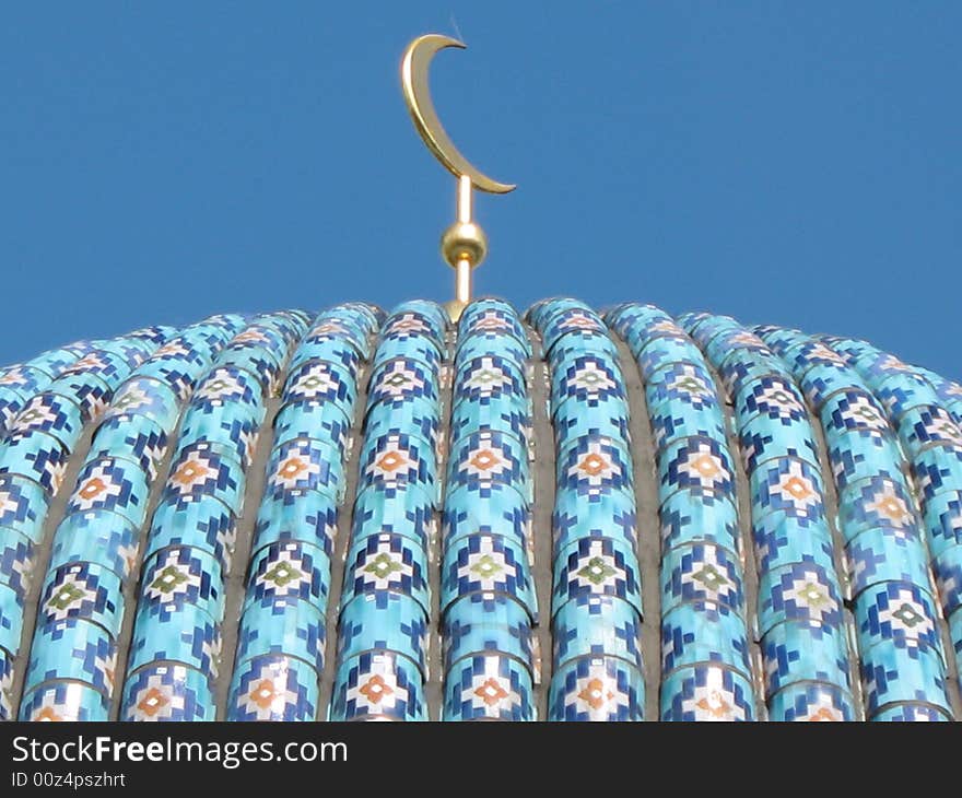 A fragment of the cupola of St. Petersburg's cathedral mosque on the blue sky background. Ceramic pattern. A fragment of the cupola of St. Petersburg's cathedral mosque on the blue sky background. Ceramic pattern.