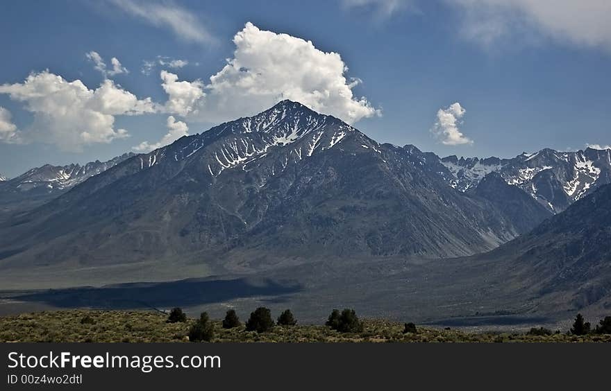 Clouds over the high desert landscape in the Eastern Sierra Nevada Mountains in California. Clouds over the high desert landscape in the Eastern Sierra Nevada Mountains in California.