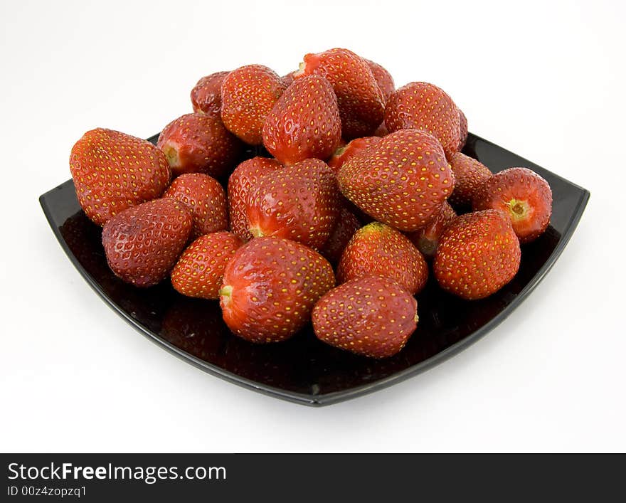 Strawberries on plate isolated on white