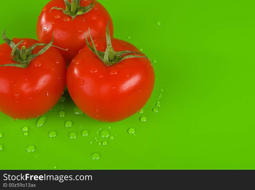 Three Tomatoes On Green