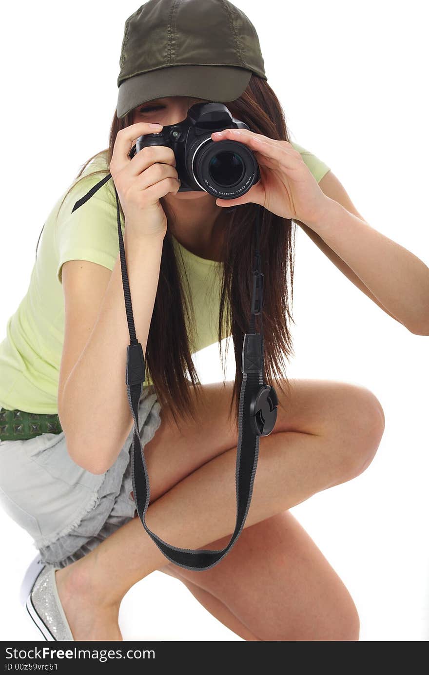 Young beautiful woman holding a photo camera. Isolated over white background. Young beautiful woman holding a photo camera. Isolated over white background