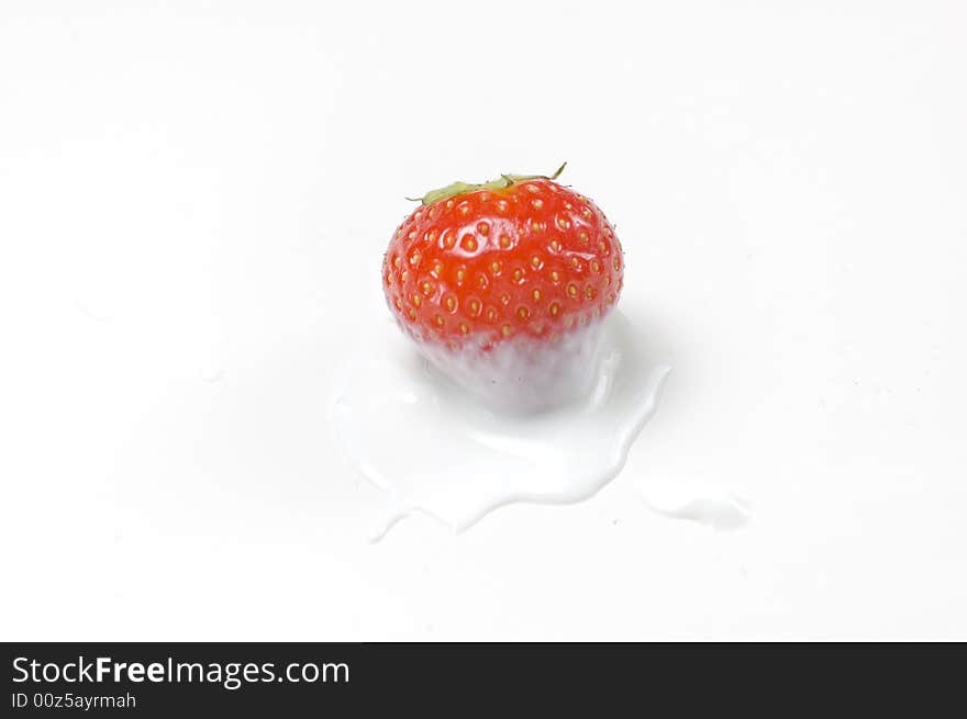 Red strawberry isolated on white dipped in yoghurt