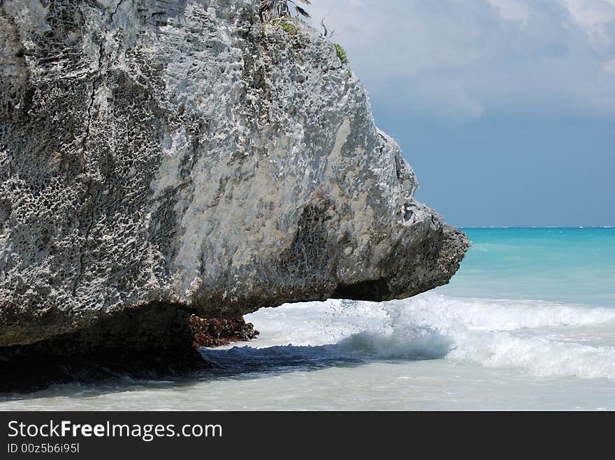 The rock that was shaped by the sea on Tulum beach, Mexico. The rock that was shaped by the sea on Tulum beach, Mexico.