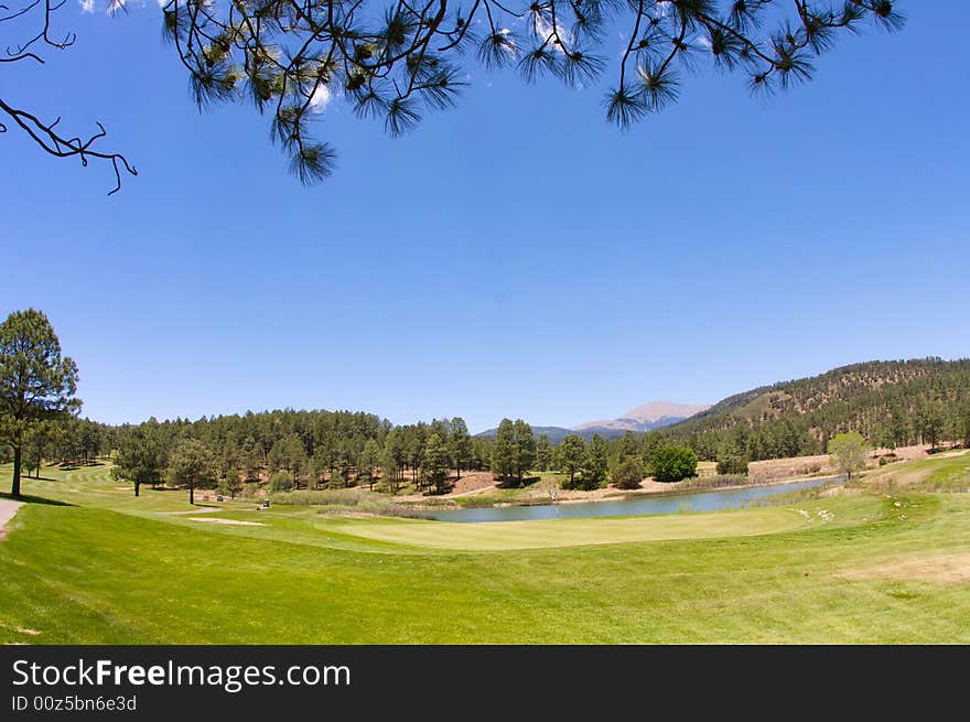 An image of a Arizona golf course with lush vegetation and mountain peaks. An image of a Arizona golf course with lush vegetation and mountain peaks