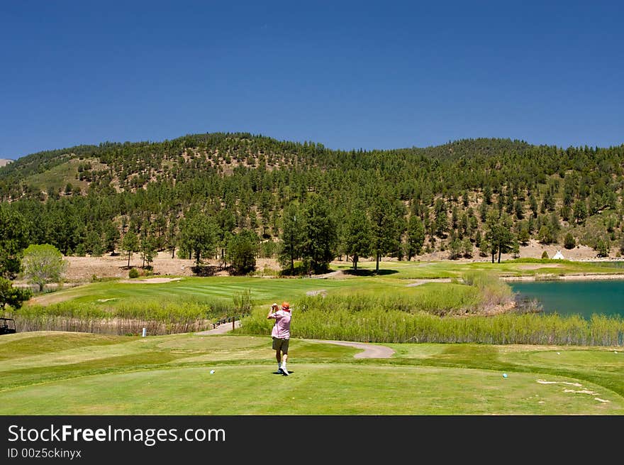 An image of a golfer following through on a swing. An image of a golfer following through on a swing