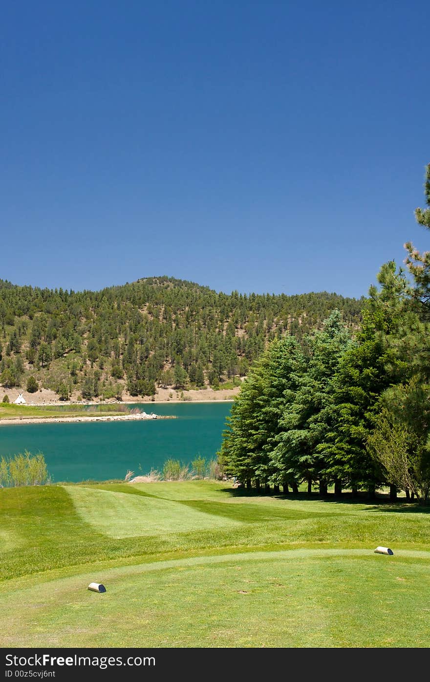 An image of a aqua lake set near a golf hole. An image of a aqua lake set near a golf hole