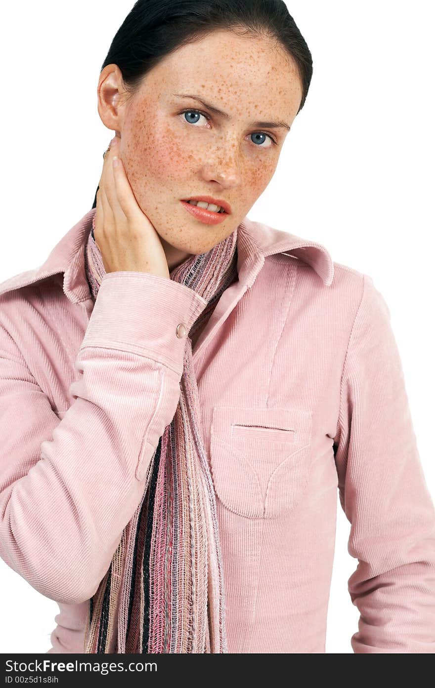 Portrait of a beautiful brunette woman with light blue eyes and freckles on her skin, wearing pink winter jacket and colorful scarf. Portrait of a beautiful brunette woman with light blue eyes and freckles on her skin, wearing pink winter jacket and colorful scarf