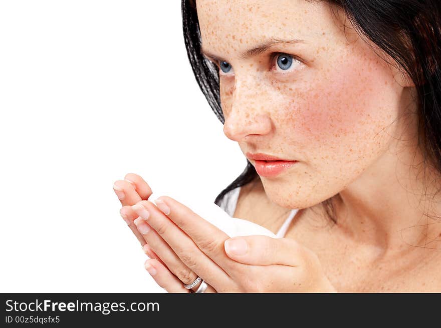 Portrait of a beautiful brunette woman with light blue eyes and freckles on her skin, holding a bar of soap. Portrait of a beautiful brunette woman with light blue eyes and freckles on her skin, holding a bar of soap