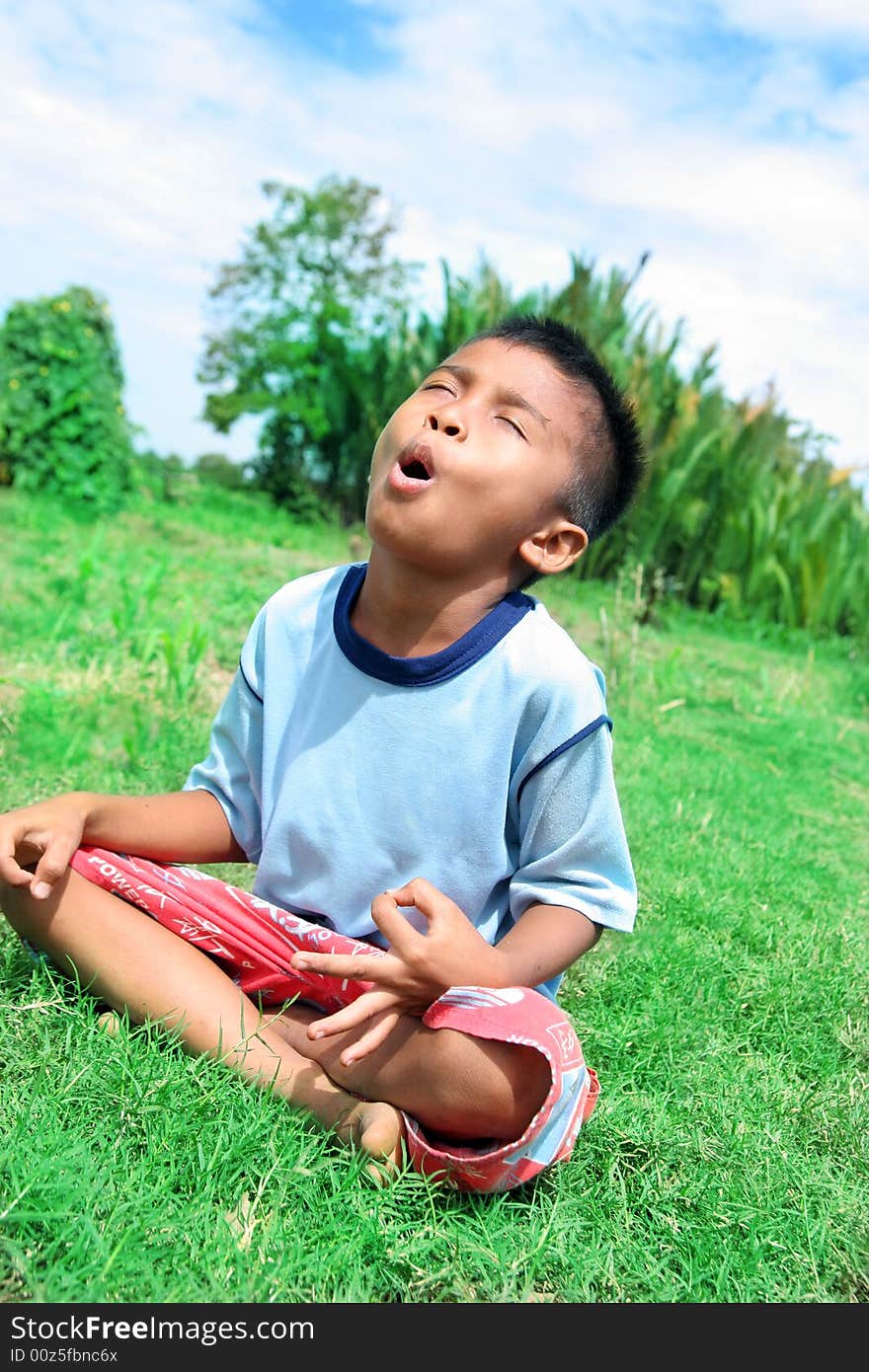 Photograph of toddle trying to relax in nature at tropical hot sun