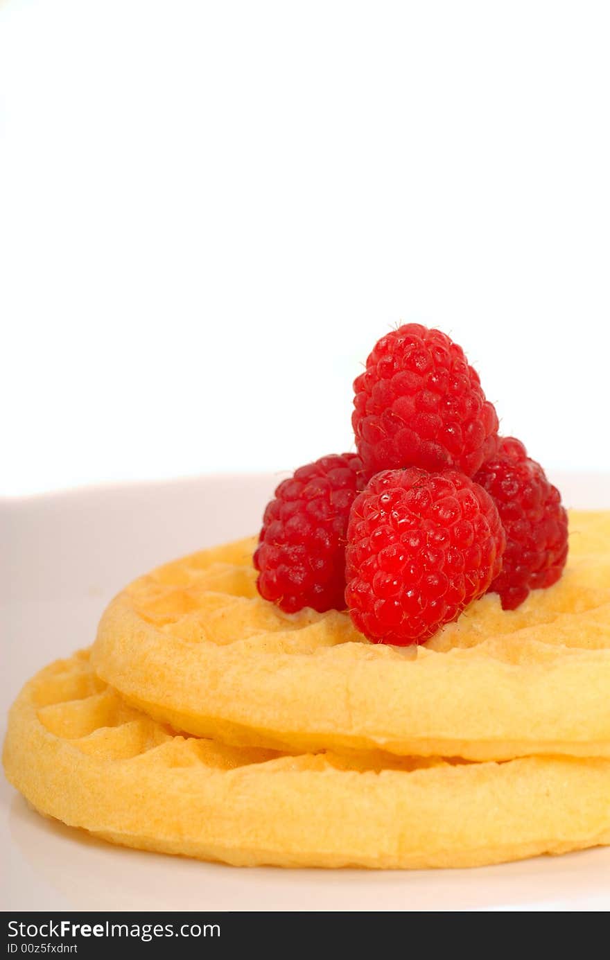 Plate of freshly made waffles with raspberries. Plate of freshly made waffles with raspberries