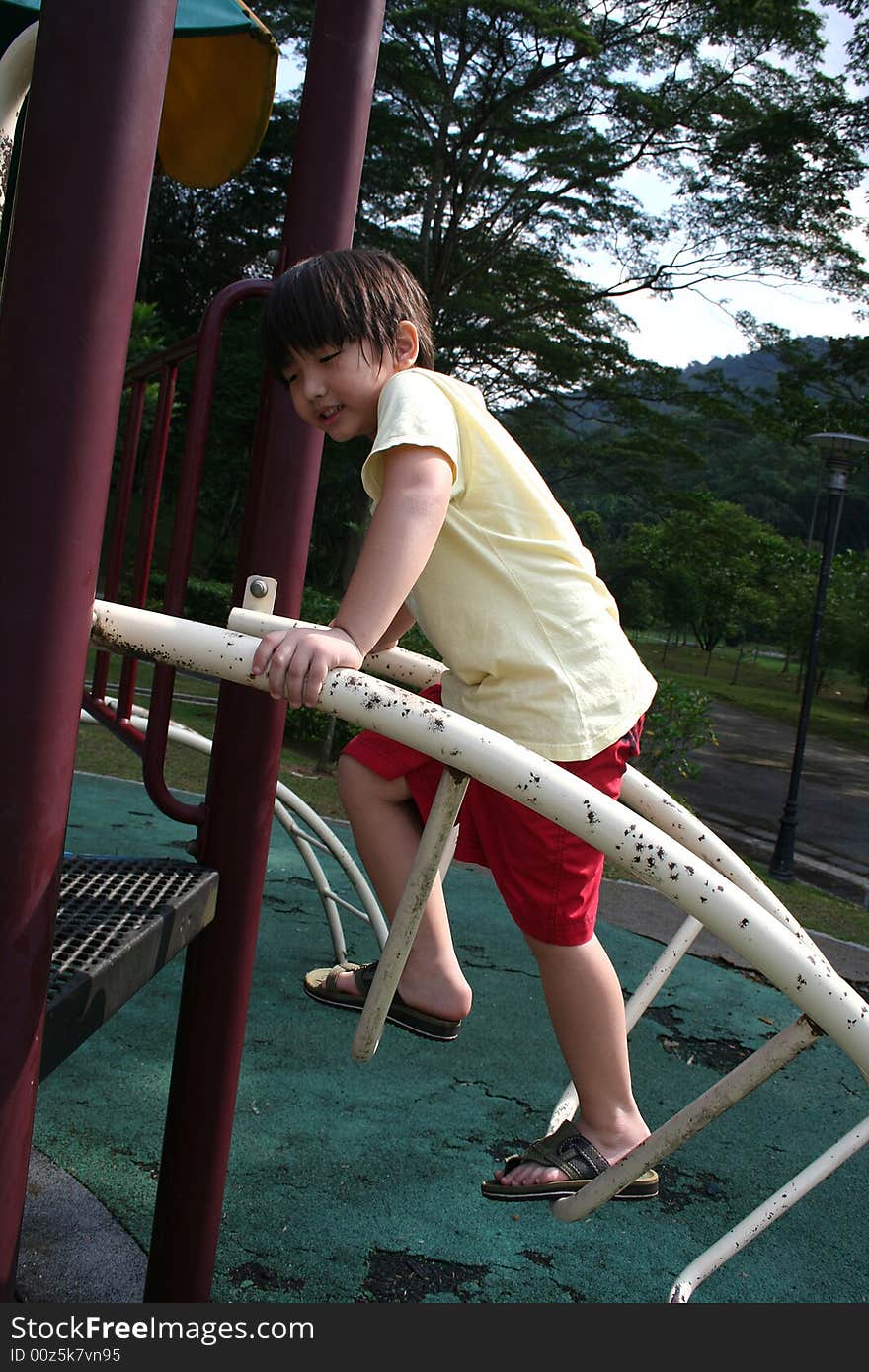 Boy climbing up slide