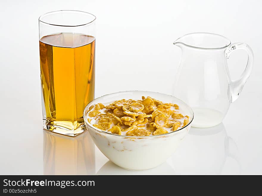 Big glass of apple juice and  corn-flakes with milk. Big glass of apple juice and  corn-flakes with milk