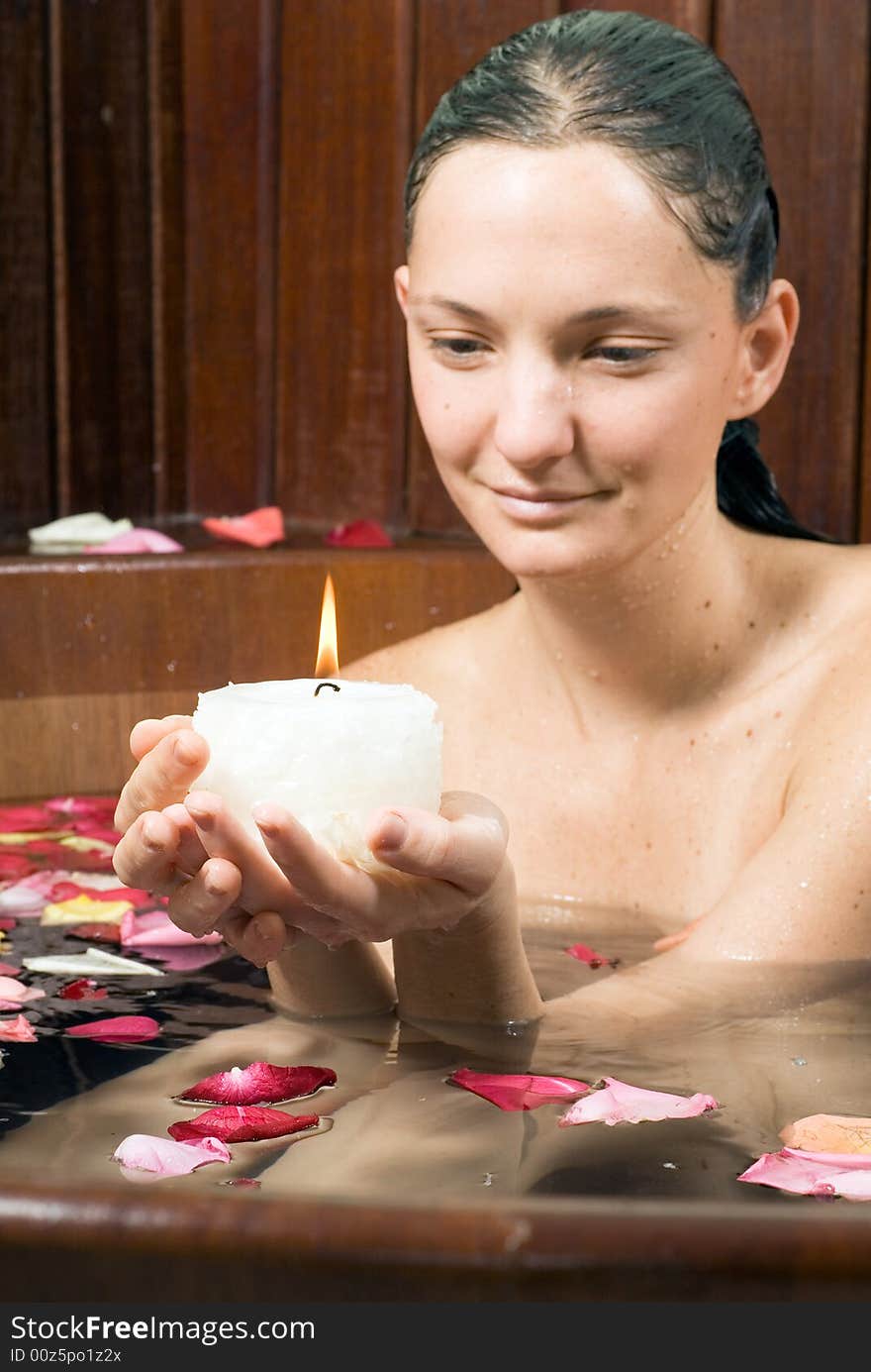 Woman In Tub With A Candle - Vertical