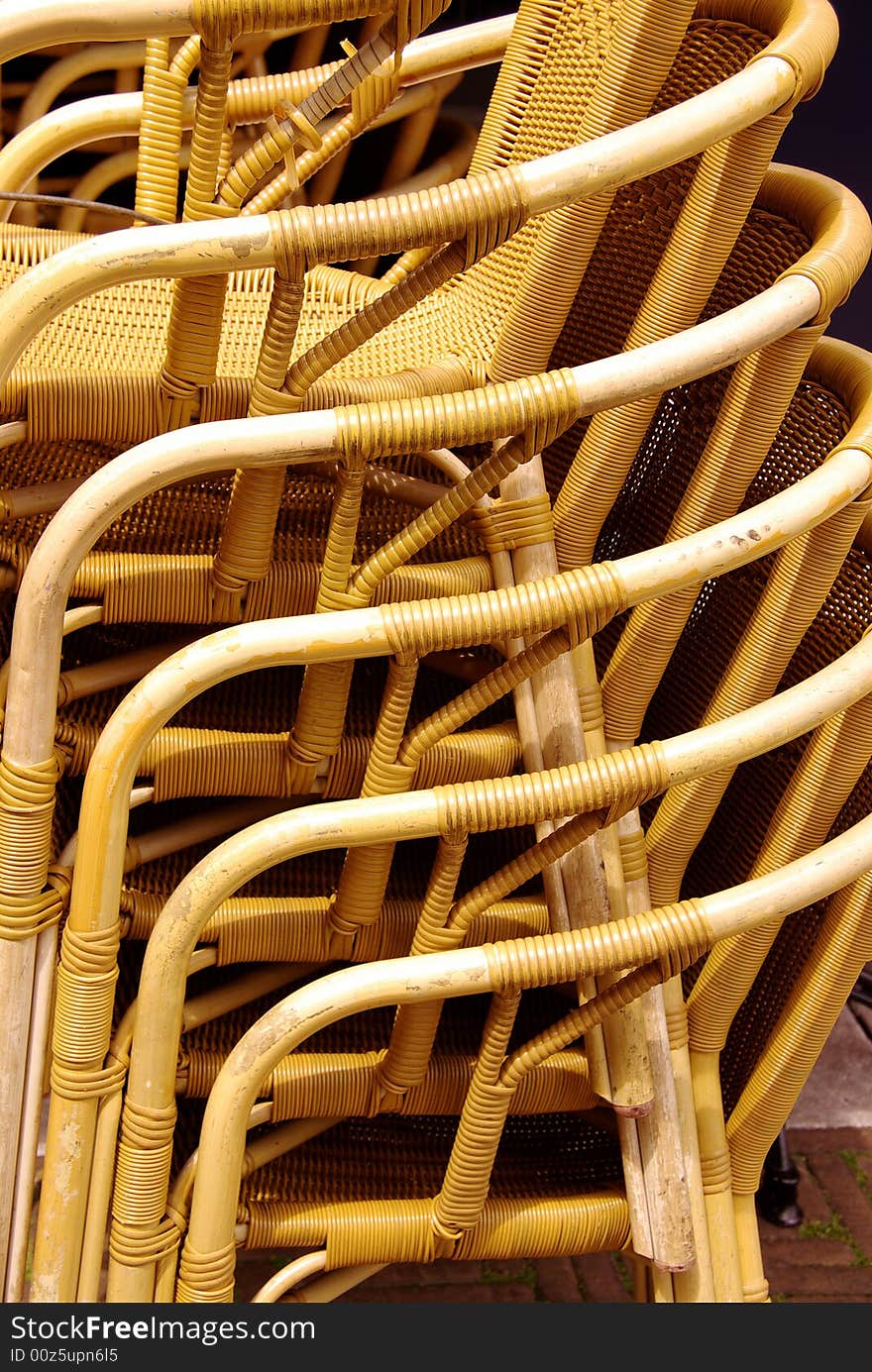 Stored stackable chairs waiting for customers at a terrace