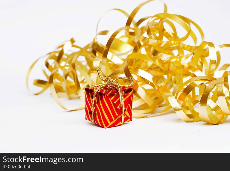 Christmas decoration - golden  ribbon and small red present