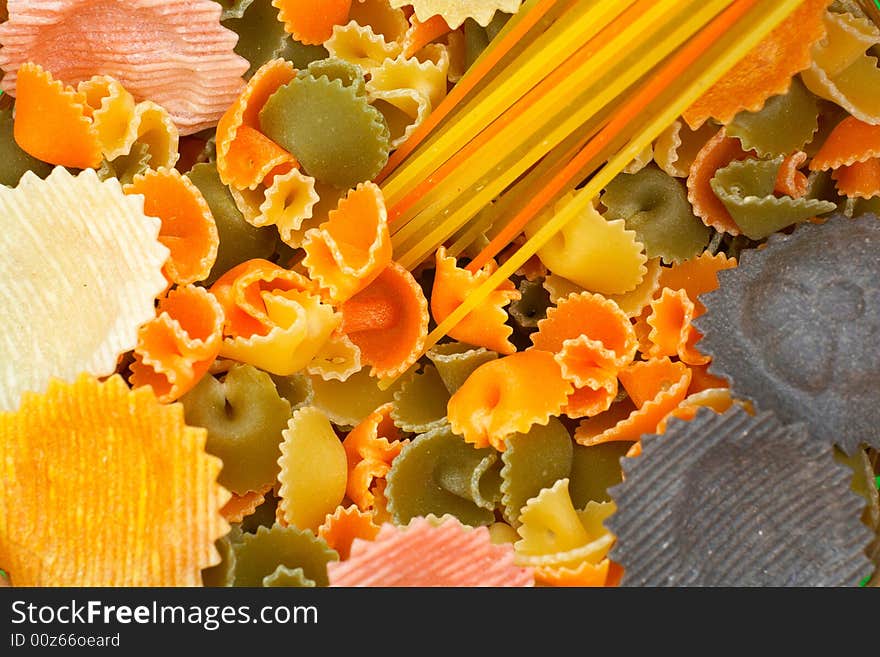 Assorted colorful uncooked pasta as background