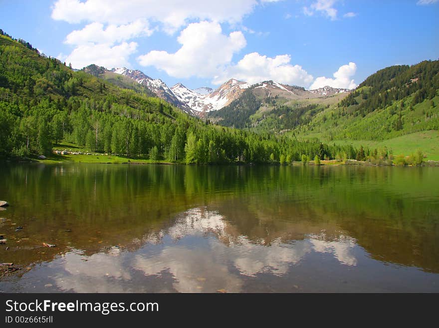 High mountain lake in the spring showing  colors reflected in the water. High mountain lake in the spring showing  colors reflected in the water