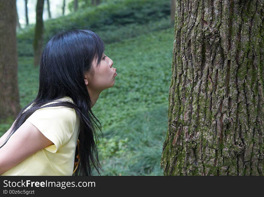 She is kissing the tree.