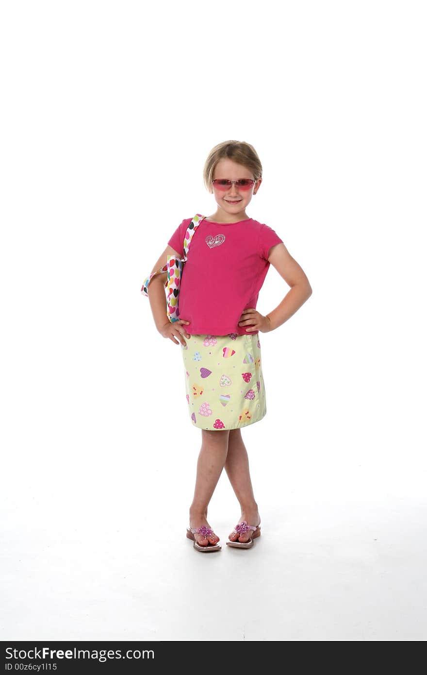 Cute girl in sunglasses, pink shirt and patterned skirt, looking like she's ready for a night on the town!