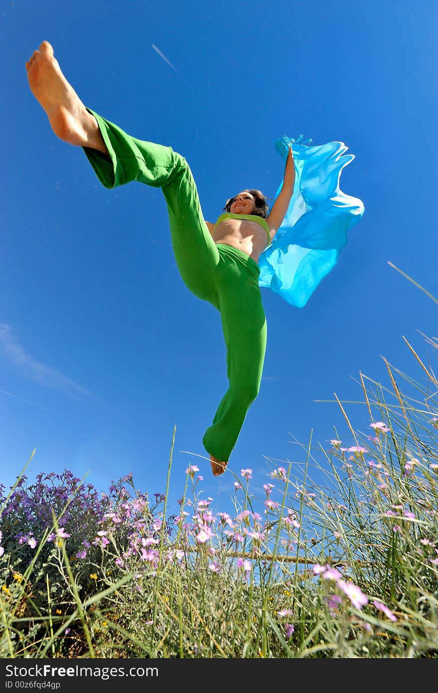 Girl with blue silk scarf jumping