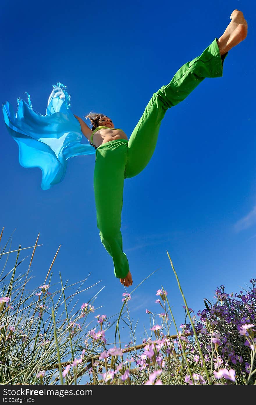 Girl with blue silk scarf jumping