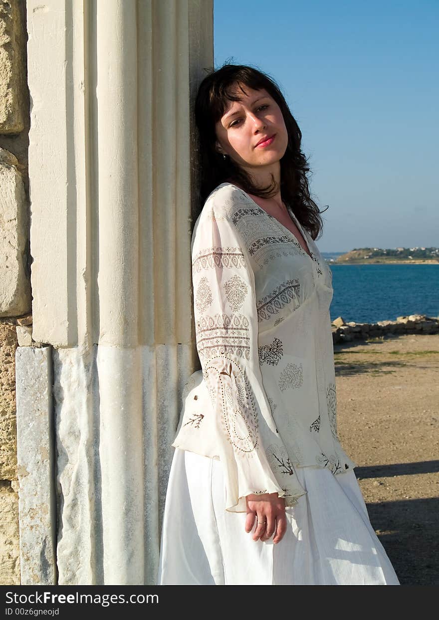 Young beautiful lady Leaning Ancient Ruins ethnic dress. Young beautiful lady Leaning Ancient Ruins ethnic dress