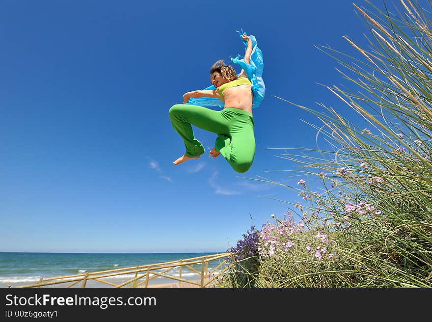 Girl with blue scarf jumping