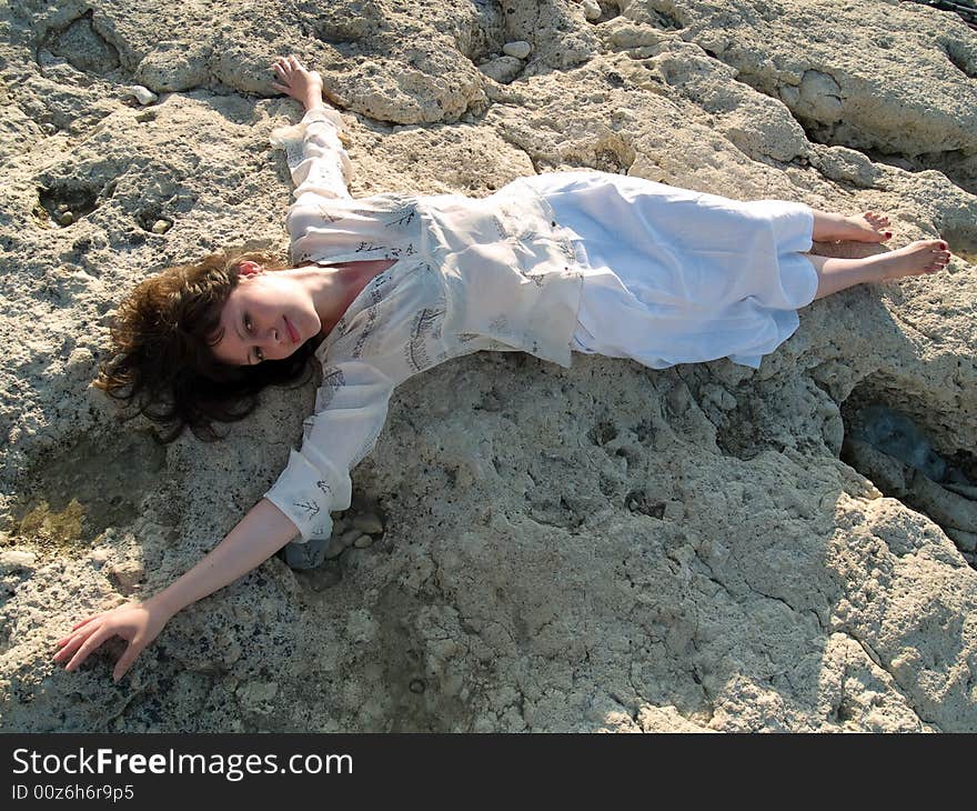 Young Barefoot Lady On Stone Beach