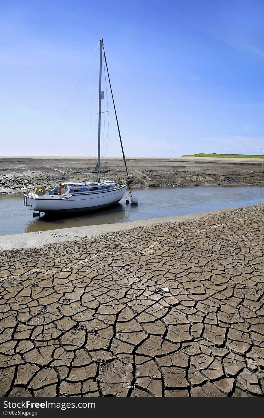 Sailing boat or yacht moored in river during period of dry weather