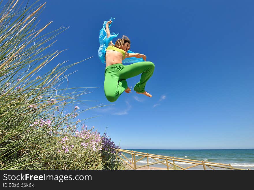 Girl with blue scarf jumping