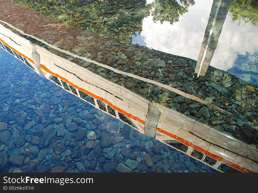 A monorail reflected in clear water. A monorail reflected in clear water