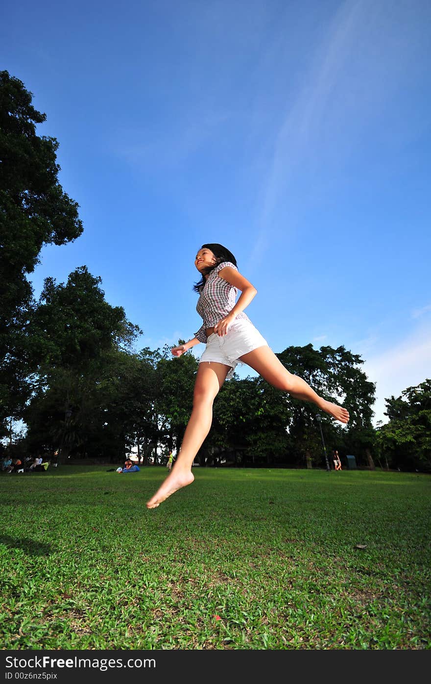 Picture of a Happy Girl out in the park. Indicative of mood, joyous occasion, promotion of healthy living and lifestyle. Picture of a Happy Girl out in the park. Indicative of mood, joyous occasion, promotion of healthy living and lifestyle.