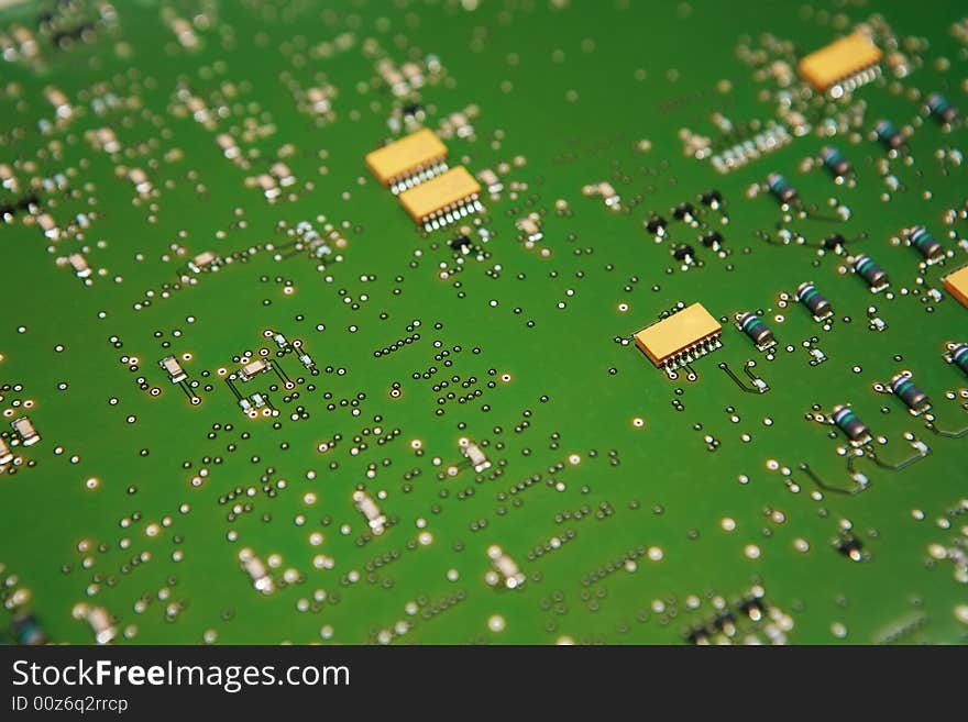 Closeup view of the component side of a circuit board. Capacitors,IC's,solder joints and traces showing. Closeup view of the component side of a circuit board. Capacitors,IC's,solder joints and traces showing.